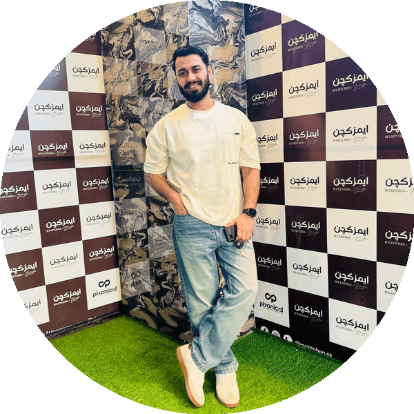 Dheeraj Ahuja smiling, wearing a cream T-shirt and jeans